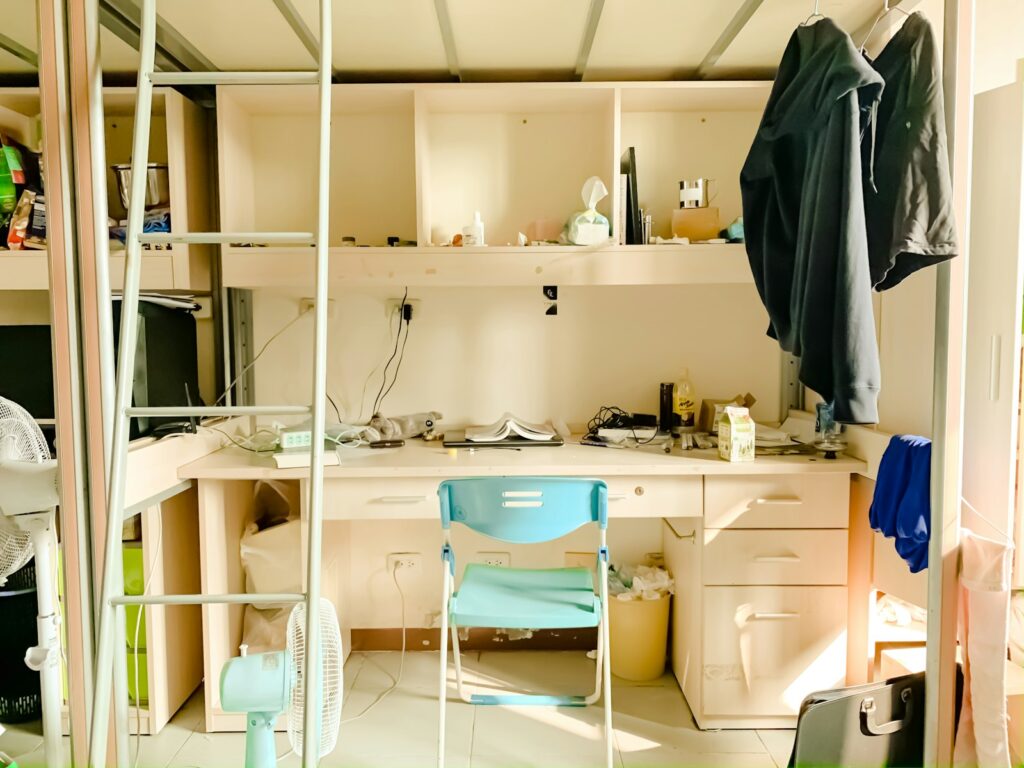 A simple student room with a chair and desk